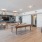 The gaming room area of the complex lounge, furnished with a pool table, on wall flat screen tv, and vinyl flooring
