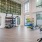 The fitness area of the complex fitted with several fitness machines, vinyl flooring, and high ceiling