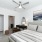 Bedroom in an apartment, equipped with a mini bathroom, queen-size bed, nightstand, vinyl flooring, and high ceiling