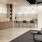 Lounge and prep area of the fitness center equipped with a prep counter, coffee maker, chairs, and vinyl flooring